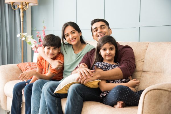 Portrait,Of,Happy,Indian,Asian,Young,Family,While,Sitting,On